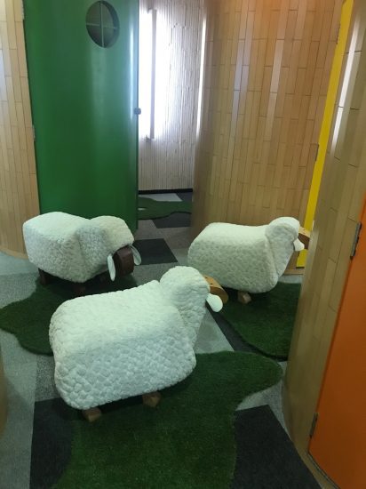 Three medium size lamb statues in a room