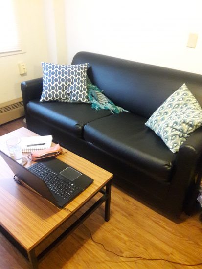 Sofa and a table with a laptop on it
