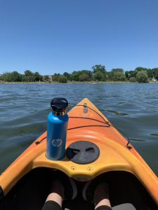 kayak on lake with water bottle