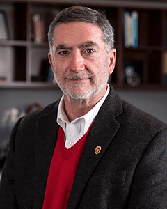 Interim Dean Barry Gerhart positioned in his office.
