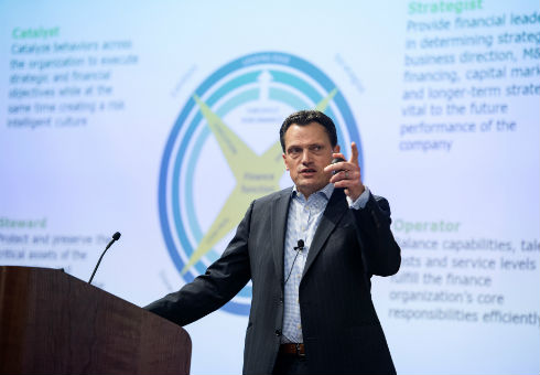 John Peirson lectures with screen in background
